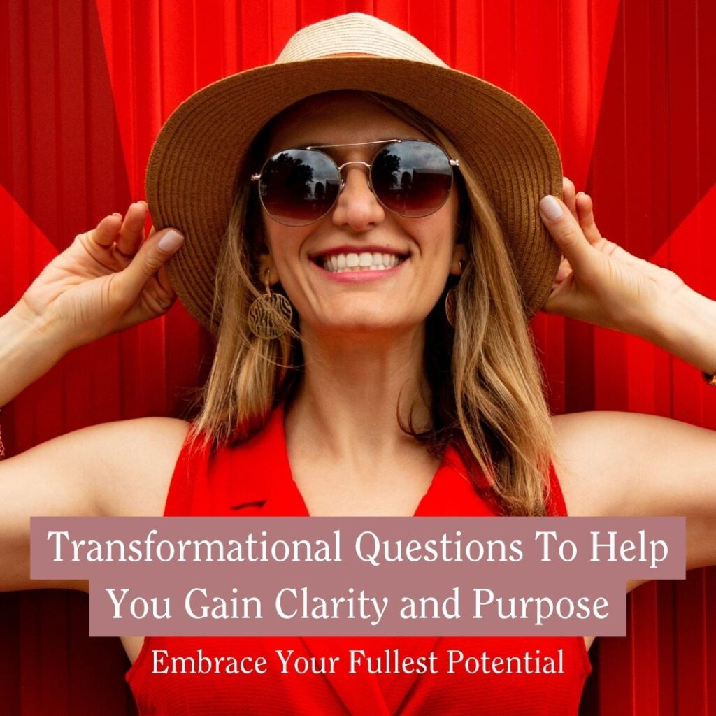 Transformational Questions To Help You Gain Clarity and Purpose - woman in red dress with sun hat and shades, smiling
